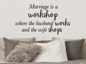 Wall decal for bedroom that says ‘Marriage is a workshop where the husband works and the wife shops’ on a bedroom wall.