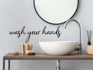 Wall decals for bathroom that say ‘Wash Your Hands’ in a cursive font on a bathroom wall.