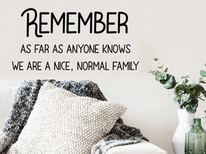Living room wall decals that say ‘Remember as far as anyone knows we are a nice, normal family’ on a living room wall. 