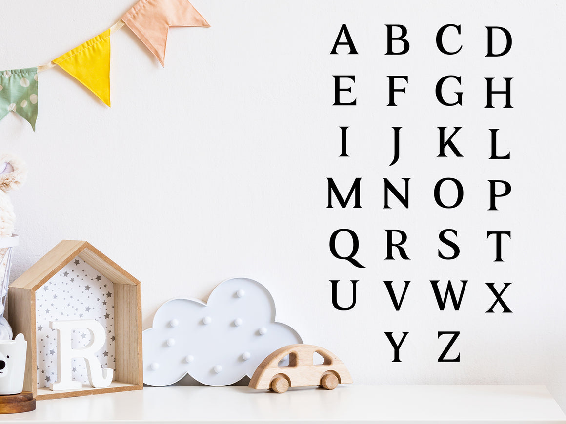 Decorative wall decal that has all the letters of the alphabet arranged in 4 columns on a kid’s room wall. 