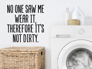 Decorative wall decal that says ‘No One Saw Me Wear It Therefore It's Not Dirty’ on a laundry room wall.