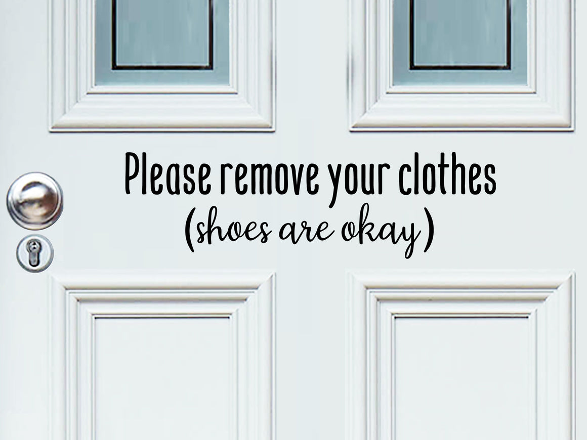 Front door decal that says, ‘please remove your clothes shoes are okay’ on a front porch door. 
