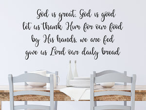 Decorative wall decal that says ‘God is Great, God Is Good’ on a kitchen wall.