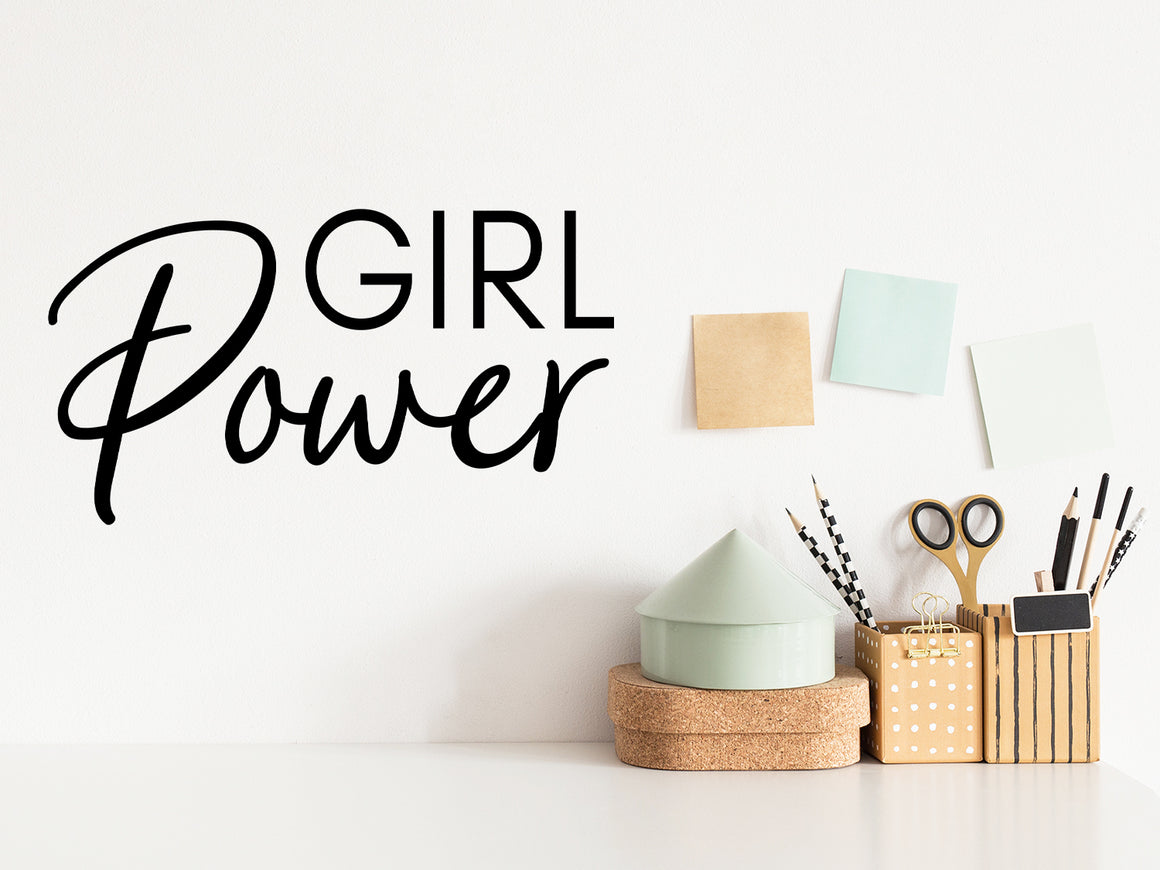 Wall decal for the office that says ‘Girl Power’ in a script font on an office wall.