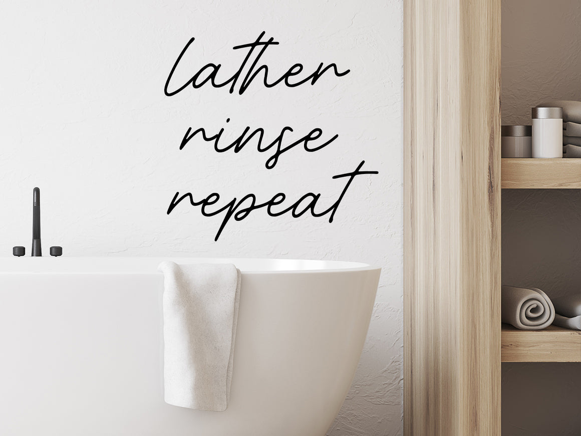 Wall decals for the bathroom that say ‘lather rinse repeat’ on a bathroom wall.