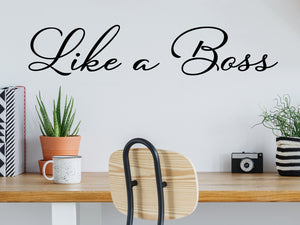 Wall decal for the office that says ‘Like A Boss’ in a cursive font on an office wall.