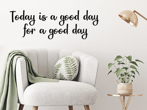 Living room wall decals that say ‘today is a good day for a good day’ in cursive on a living room wall. 