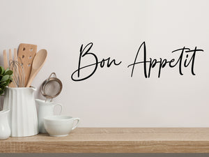 Wall decals for kitchen that say ‘Bon Appetit’ in a script font on a kitchen wall.