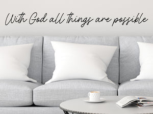 Living room wall decals that say ‘With God all things are possible’ on a living room wall. 