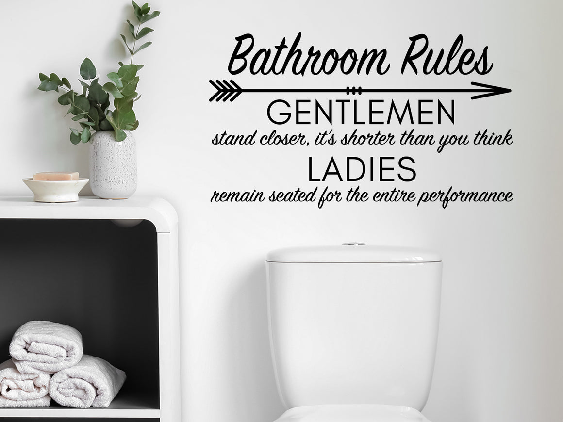 Wall decals for bathroom that say ‘Bathroom Rules (Gentleman & Ladies)’ in a cursive font on a bathroom wall.
