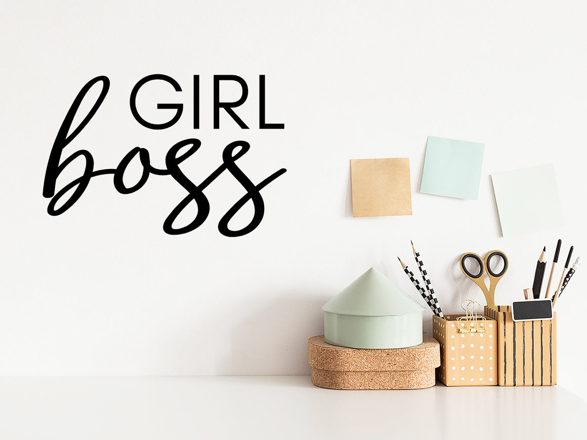 Wall decal for the office that says ‘Girl Boss’ in a script font on an office wall.