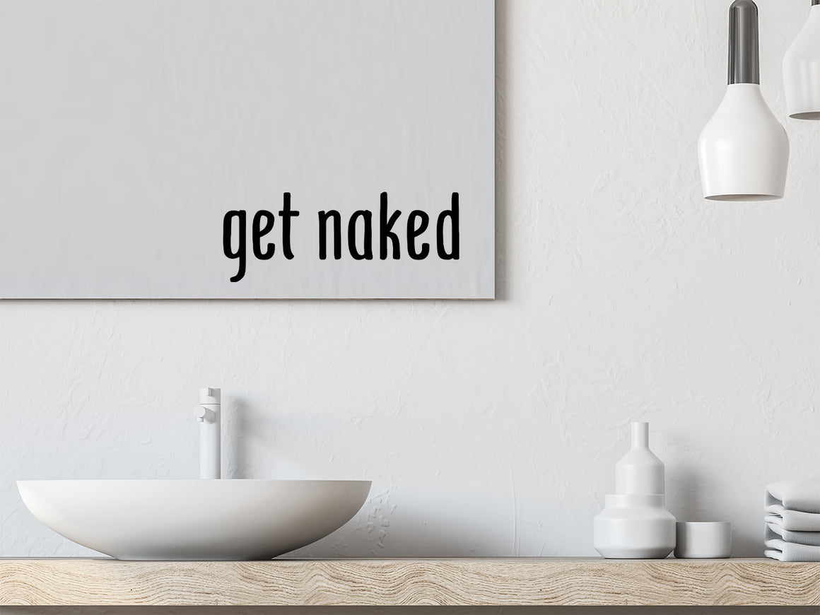 Wall decals for bathroom that say ‘get naked’ in a print font on a bathroom wall.