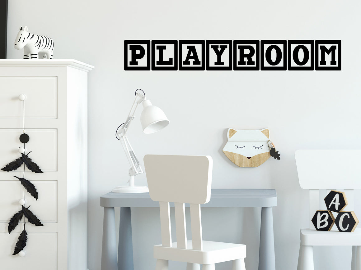 Wall decal for kids that says ‘Playroom’ with a block design on a kid’s room wall. 