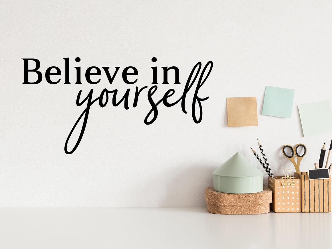 Wall decal for the office that says ‘Believe In Yourself’ in a script font on an office wall.