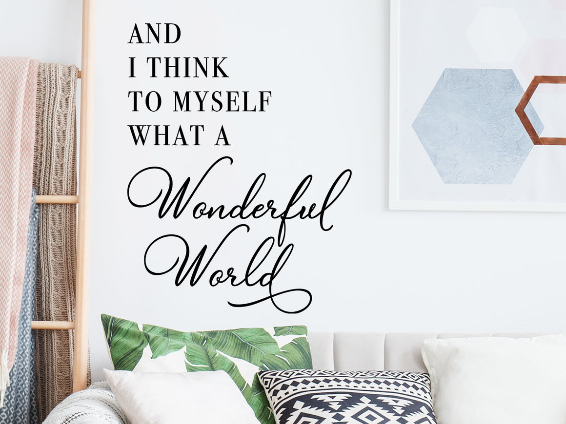 Living room wall decals that say ‘and I think to myself what a wonderful world’ with a script font on a living room wall. 