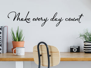 Wall decal for the office that says ‘Make Every Day Count’ in a cursive font on an office wall.