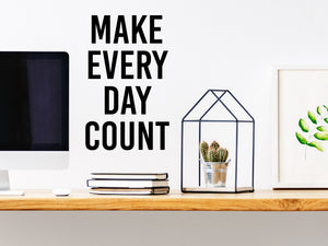 Wall decal for the office that says ‘Make Every Day Count’ in a bold font on an office wall.