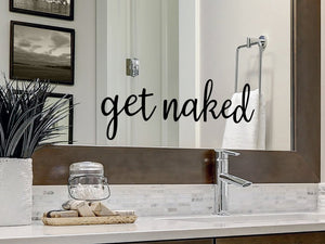 Wall decal for the bathroom mirror that says ‘get naked' on a bathroom mirror.