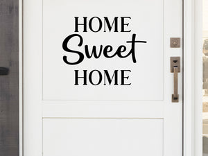 Front door decal that says, ‘Home Sweet Home' in a script font on a front porch door. 