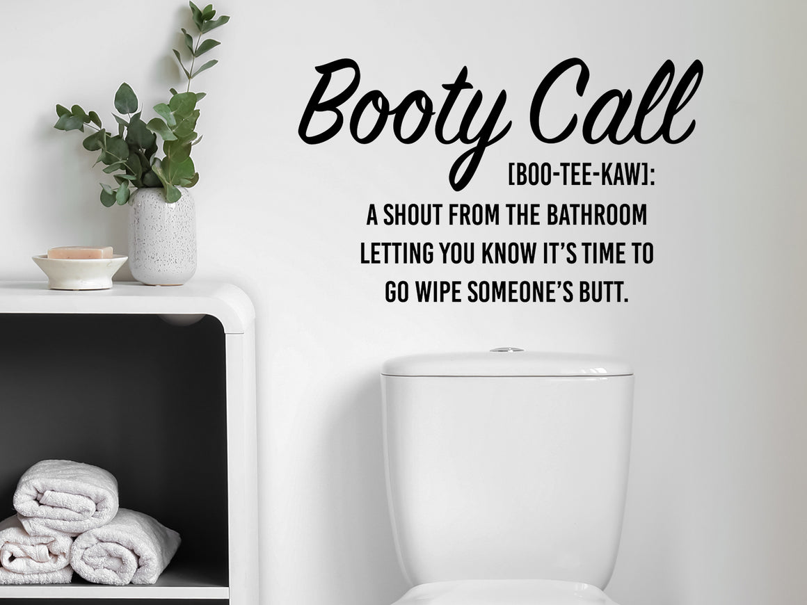 Wall decals for bathroom that say ‘Booty Call Definition’ in a cursive font on a bathroom wall.