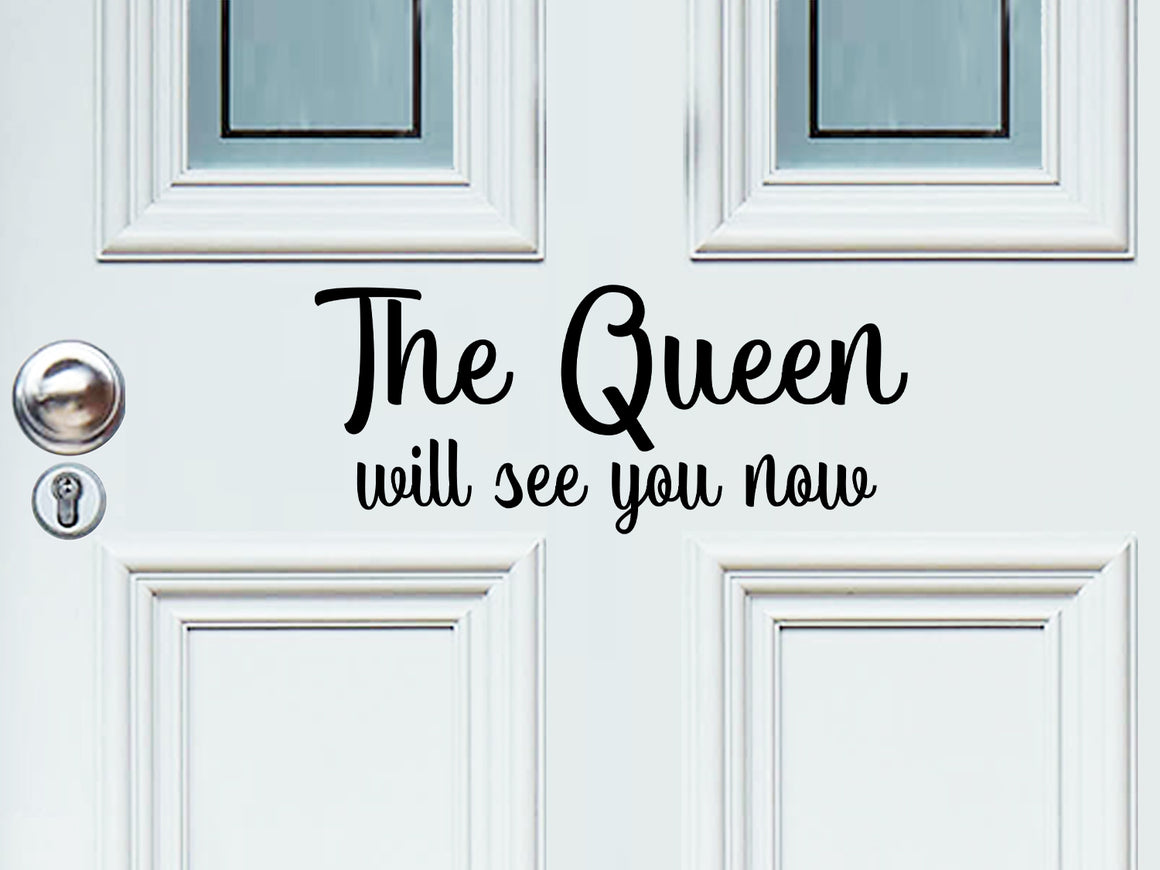 Front door decal that says, ‘The Queen Will See You Now’ on a front porch door. 