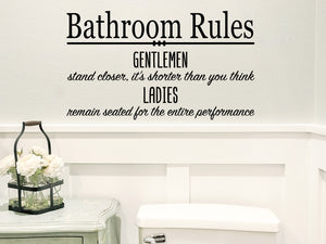 Wall decal for bathroom that says 'Bathroom Rules Gentlemen stand closer it’s shorter than you think Ladies remain seated for the entire performance' on a bathroom wall.