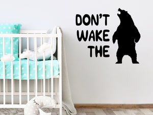 Wall decal for kids that says ‘Don't Wake The Bear’ in a bold font on a kid’s room wall. 
