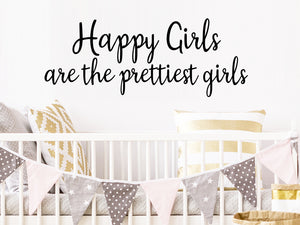 Wall decal for kids that says ‘Happy girls are the prettiest girls’ on a kid’s room wall. 