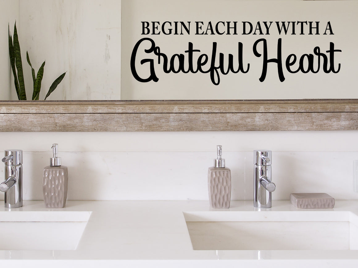 Wall decals for bathroom that say ‘Begin Each Day With A Grateful Heart’ in a script font on a bathroom wall.