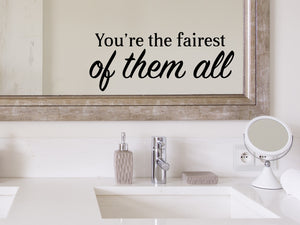 Wall decals for bathroom that say ‘You're The Fairest Of Them All’ in a bold font on a bathroom mirror.