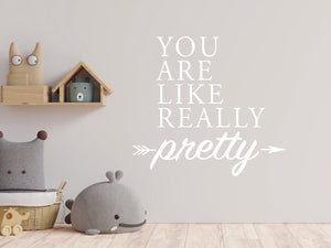 Wall decal for kids in a white color that says ‘You Are Like Really Pretty’ with an arrow design on a kid’s room wall. 