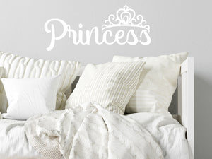 Wall decal for kids in white that says ‘Princess’ in a script font on a kid’s room wall. 