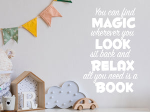Wall decal for kids in a white color that says ‘You Can Find Magic Wherever You Look’ in a dual font on a kid’s room wall. 