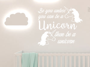 Wall decal for kids in a white color that says ‘Always Be You Unless You Can Be A Unicorn’ on a kid’s room wall. 