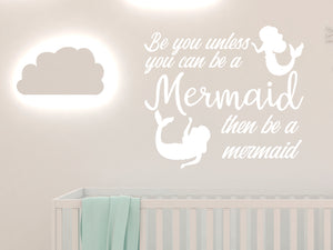 Wall decal for kids in a white color that says ‘Always Be You Unless You Can Be A Mermaid’ on a kid’s room wall. 