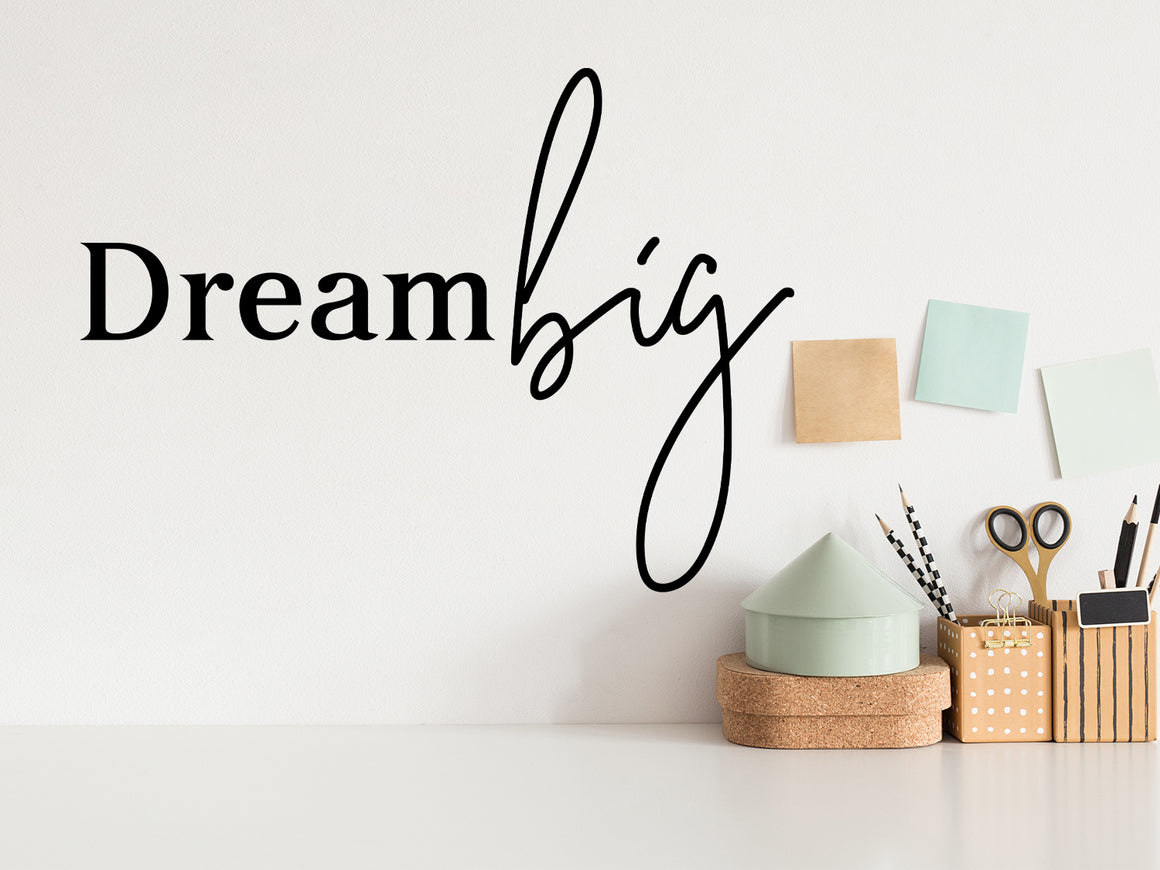 Wall decal for the office that says ‘Dream Big’ in a bold font on an office wall.